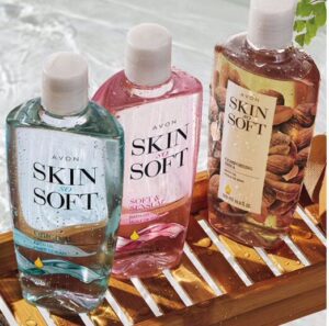 Three bottles of skin soft are sitting on a wooden tray.