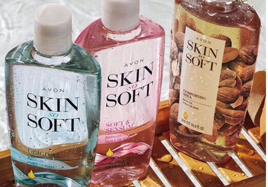 Three Avon Skin So Soft bath oil bottles.