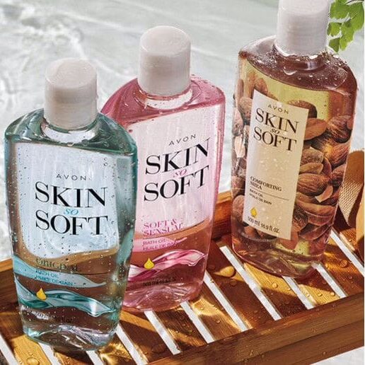 Three bottles of skin soft are sitting on a wooden tray.